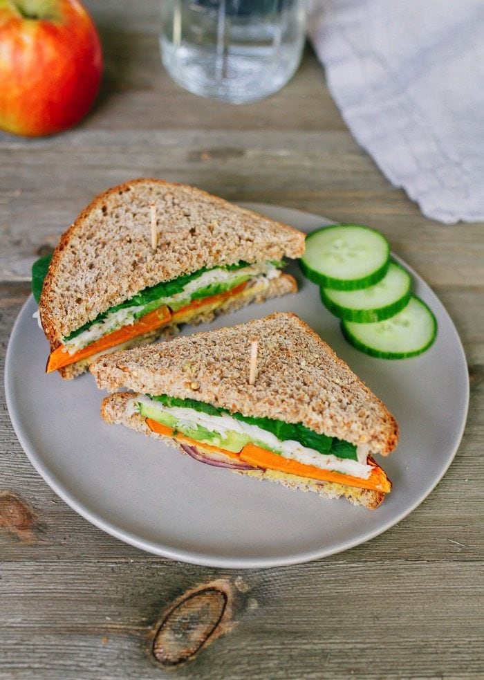 Healthy Sweet Autumn Turkey Sandwich packed with crispy apple slices, roasted sweet potato, red onion, avocado and a honey mustard hummus spread.