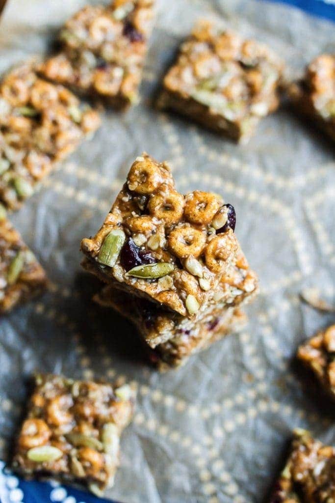 Pumpkin Spice Cereal Squares stacked on parchment paper.