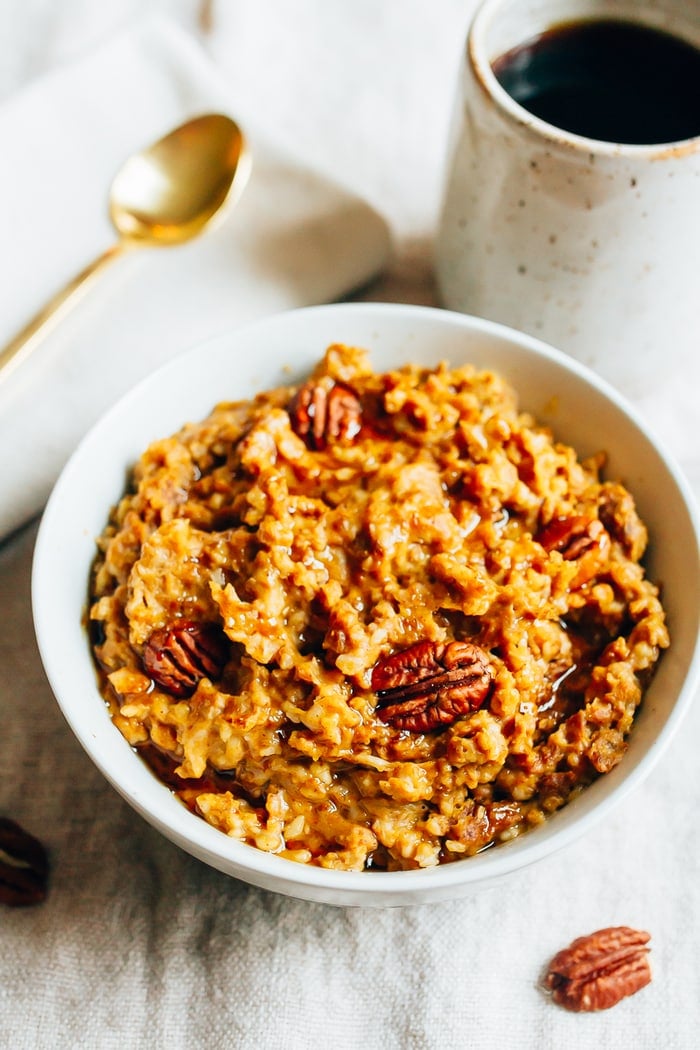 Slow Cooker Pumpkin Pie Oatmeal in a white bowl with pecans.