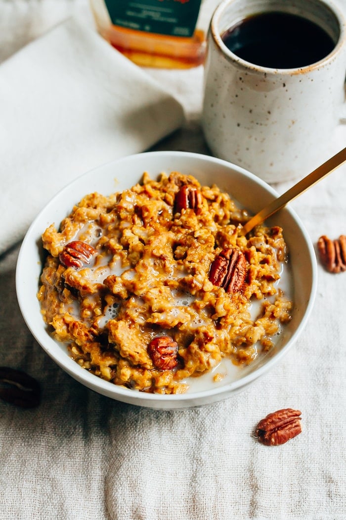 Slow Cooker Pumpkin Pie Oatmeal in a shallow bowl topped with pecans. 