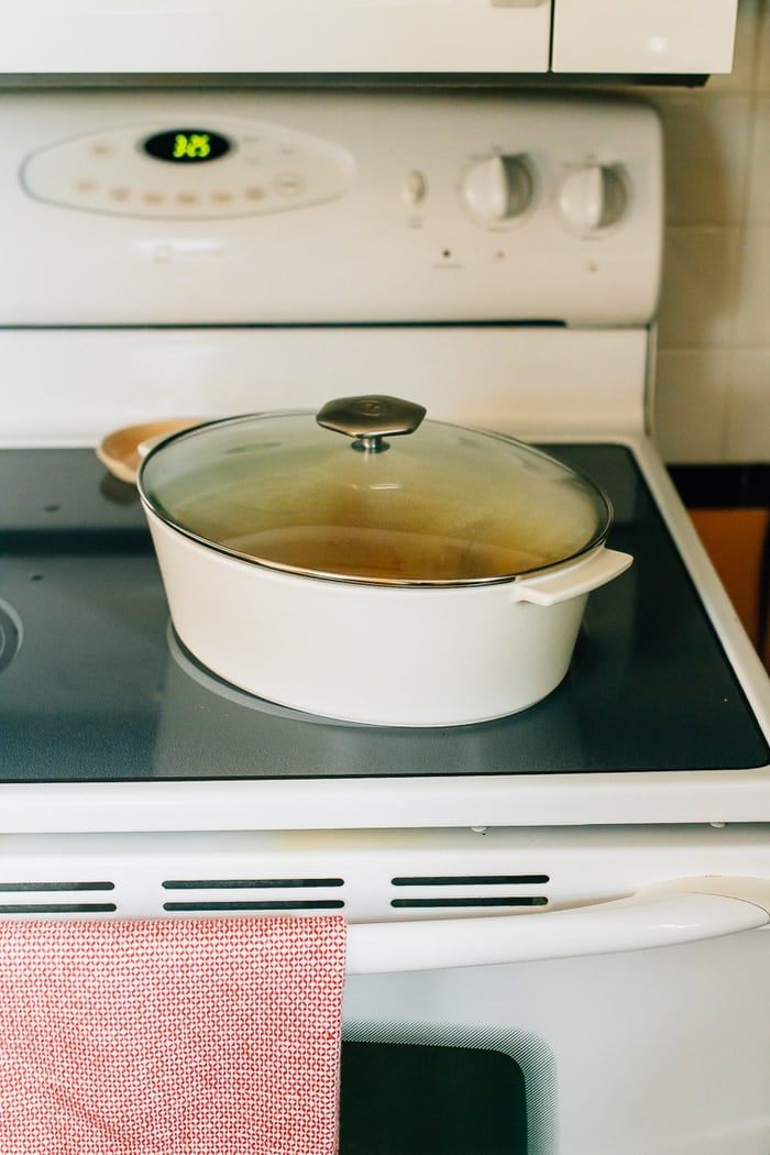 White dutch oven on a stove top.