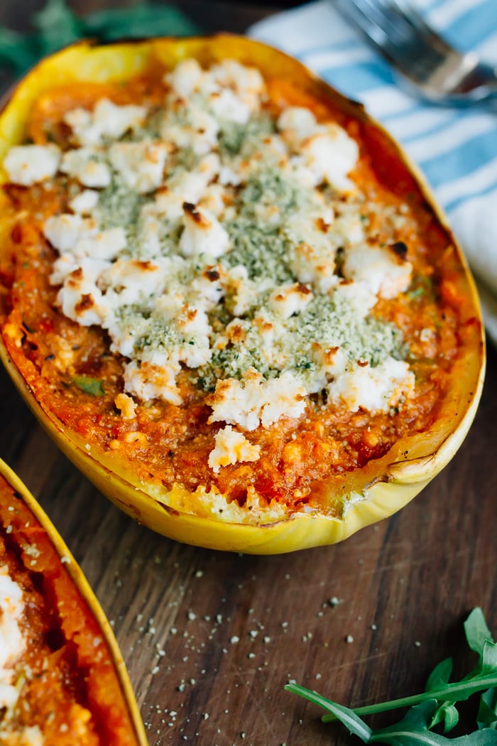 Spaghetti squash lasagna boat with sauce and topped with vegan cheese.