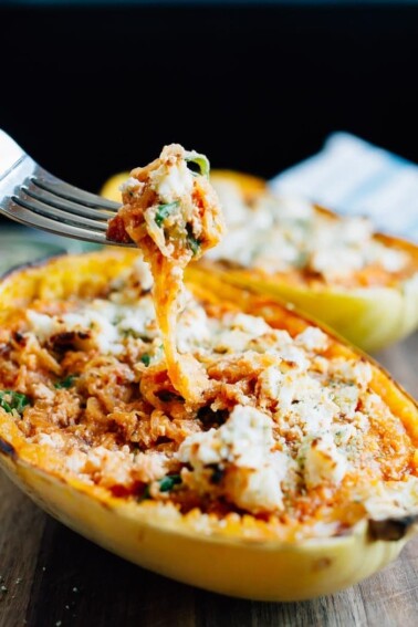 Fork taking a spoonful of spaghetti squash from a lasagna spaghetti squash boat.