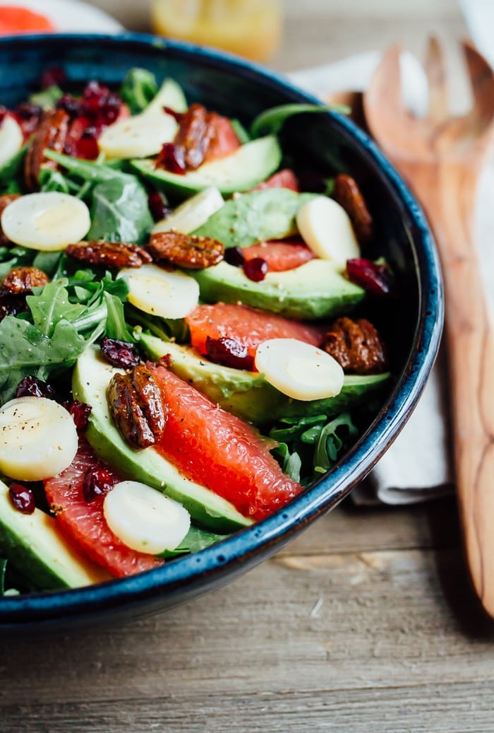 A festive winter grapefruit avocado salad with peppery arugula, hearts of palm, candied pecans, dried cranberries and a maple apple cider vinegar dressing. A festive winter grapefruit avocado salad with peppery arugula, hearts of palm, candied pecans, dried cranberries and a maple apple cider vinegar dressing.