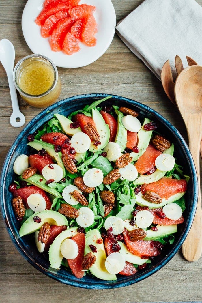 A festive winter grapefruit avocado salad with peppery arugula, hearts of palm, candied pecans, dried cranberries and a maple apple cider vinegar dressing. A festive winter grapefruit avocado salad with peppery arugula, hearts of palm, candied pecans, dried cranberries and a maple apple cider vinegar dressing.