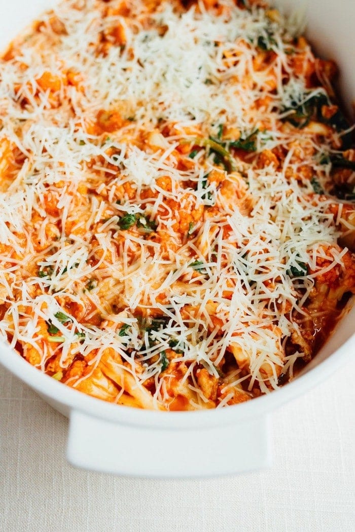 Cauliflower Baked Ziti Uncooked in a baking dish topped with cheese.