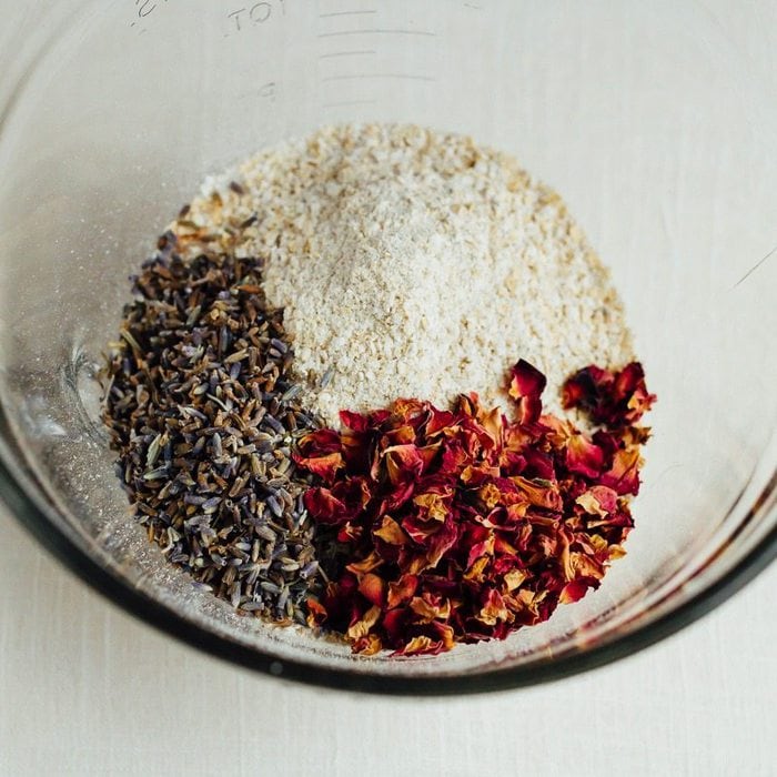 DIY lavender rose bath soak ingredients in a mixing bowl.