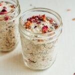 Dried lavender, oats, and rose petals with bath salt in two jars.