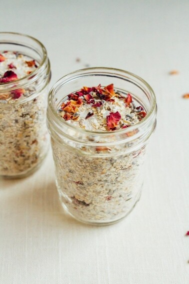 Dried lavender, oats, and rose petals with bath salt in two jars.