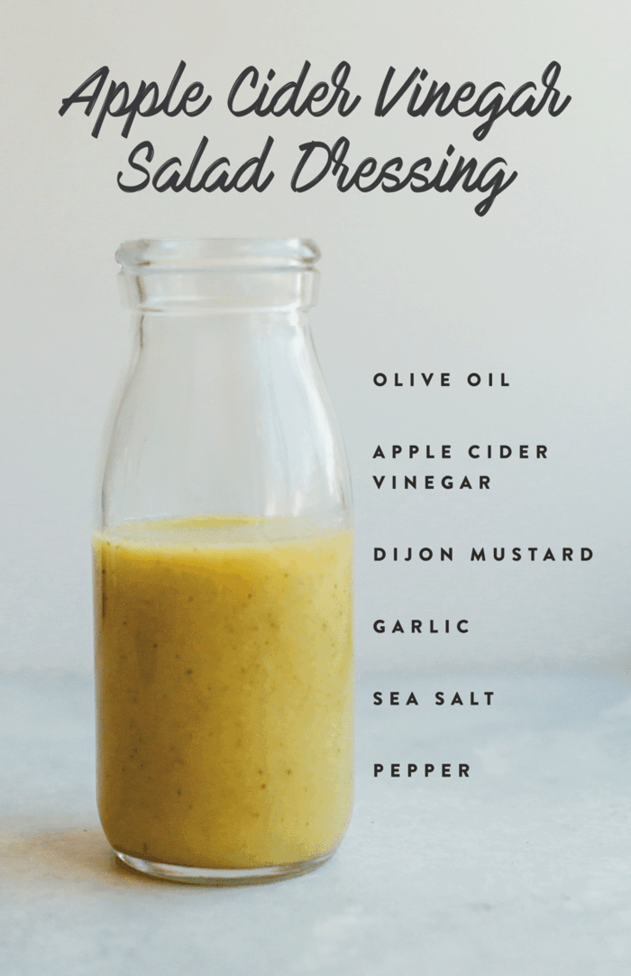 Healthy homemade apple cider vinegar salad dressing in a glass jar with ingredients listed down the side of the image. 