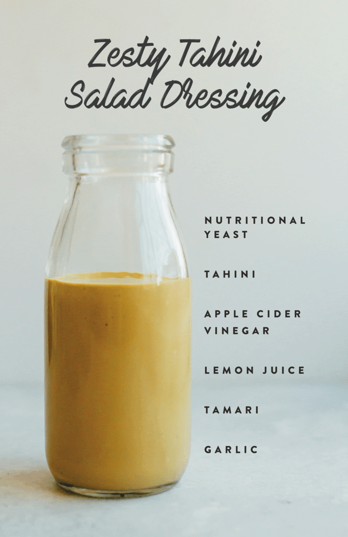 Zesty tahini salad dressing in a glass jar with ingredient text on the side. 