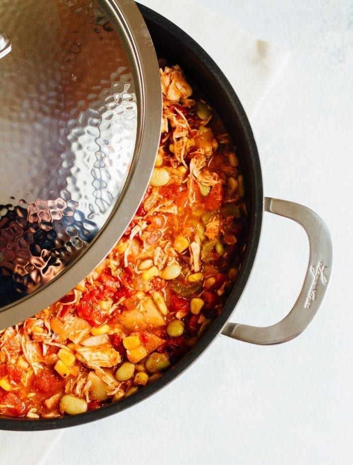 Homemade healthy Brunswick stew in a pot. Shredded chicken, lima beans, corn and tomatoes.