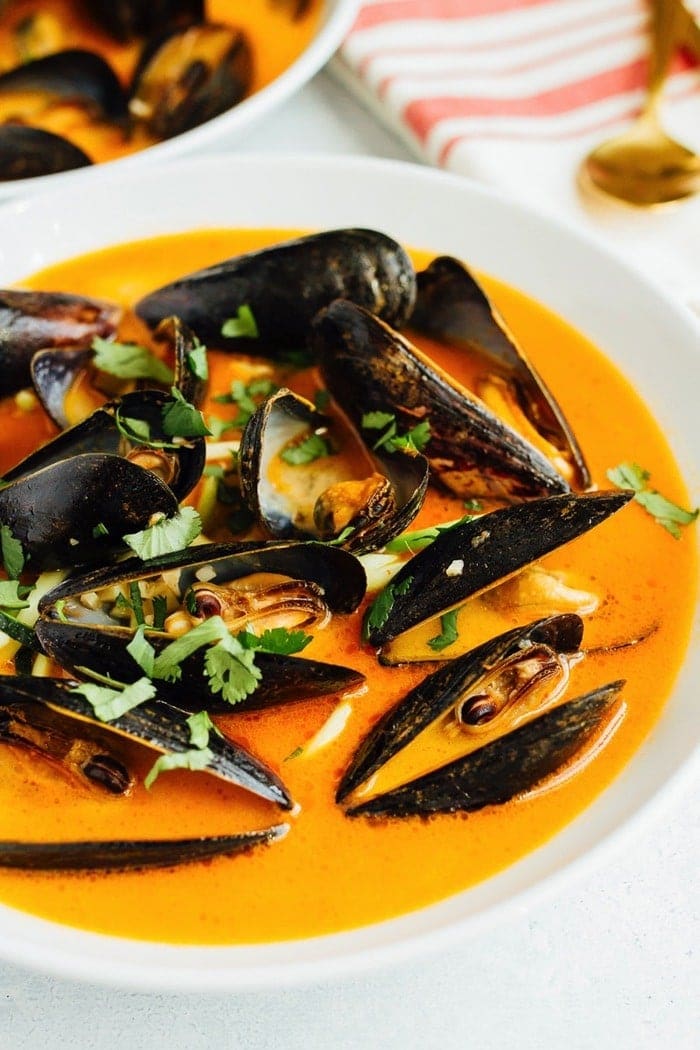 Coconut curry broth with mussels served over zucchini noodles and topped with cilantro.