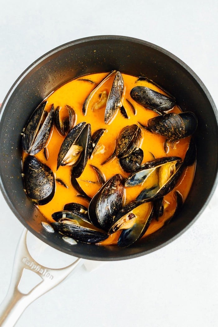 Cooking Coconut Curry Mussels in a pot.