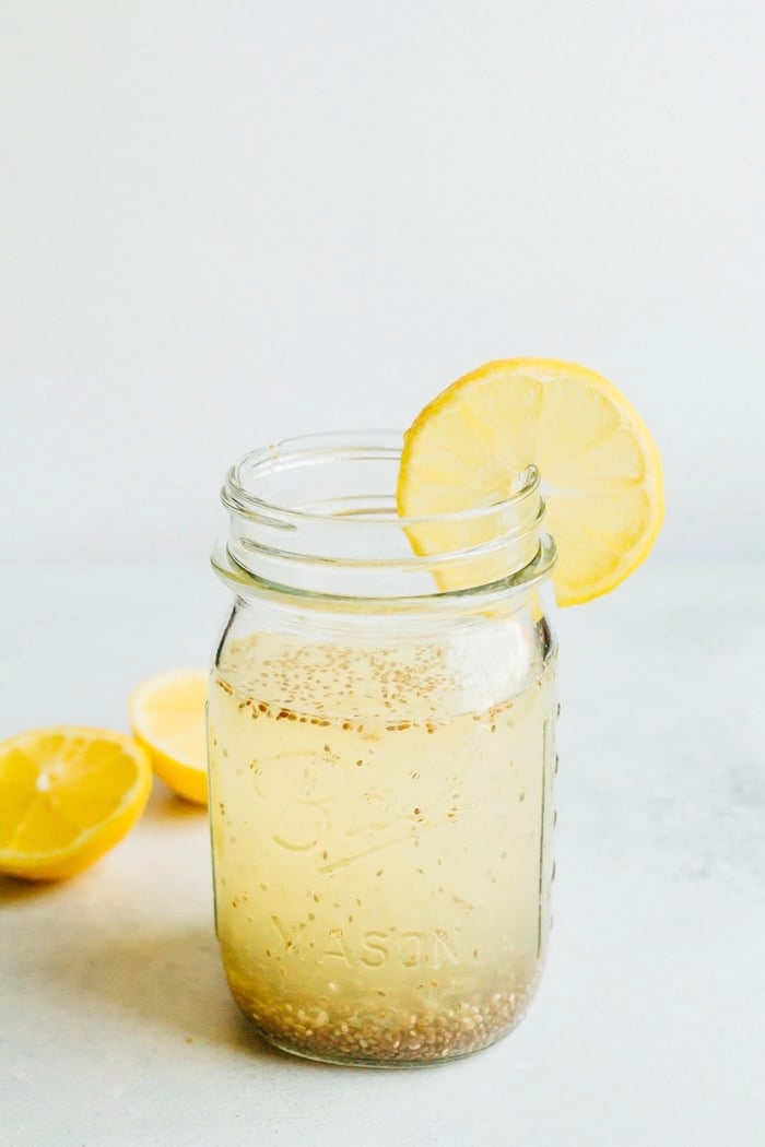 Lemon Chia Fresca in a clear mason jar with a slice of lemon.