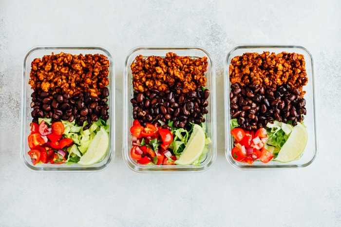 Tempeh Taco Salad Meal Prep Bowls with tempeh taco meat, black beans, tomatoes, onions and avocado