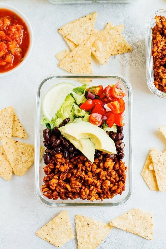 Tempeh Taco Salad Meal Prep Bowls with tempeh taco meat, black beans, tomatoes, onions and avocado