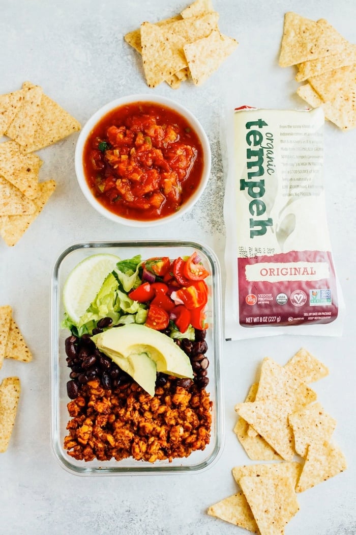 Tempeh Taco Salad Meal Prep Bowls with tempeh taco meat, black beans, tomatoes, onions and avocado