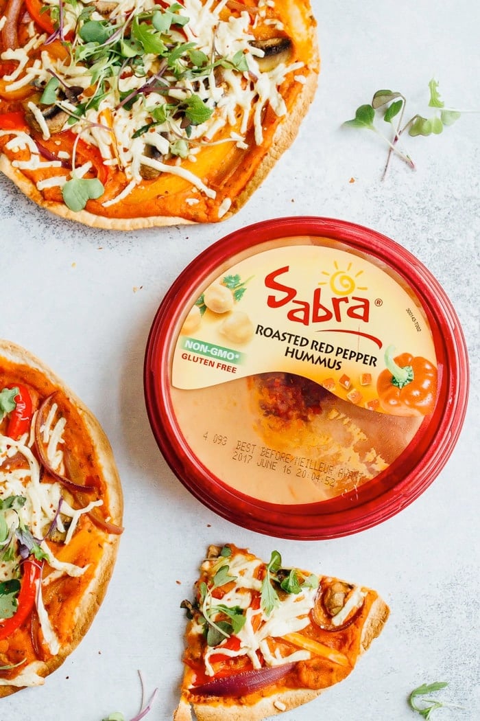 Sabra roasted red pepper hummus next to tortilla pizzas.