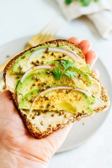 Hand holding a piece of toast