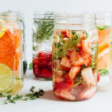 Fruit and herb infused water in mason jars.