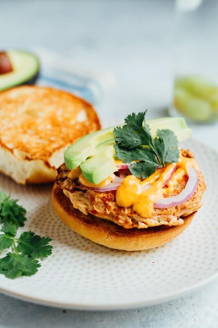 Teriyaki Salmon Burgers with Sriracha Mayo, Avocado, Red Onion and Cilantro.