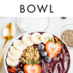 Maqui berry smoothie bowl topped with banana, strawberries, blueberries, and granola.