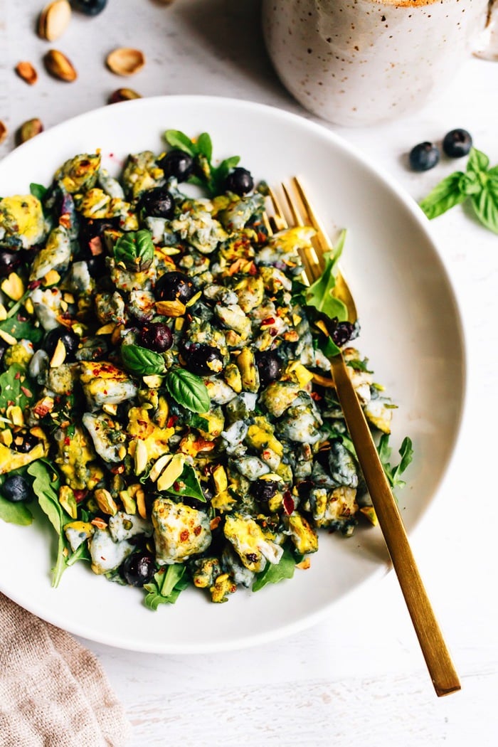 Blueberry Eggs Breakfast Salad with basil and pistachios on a plate.