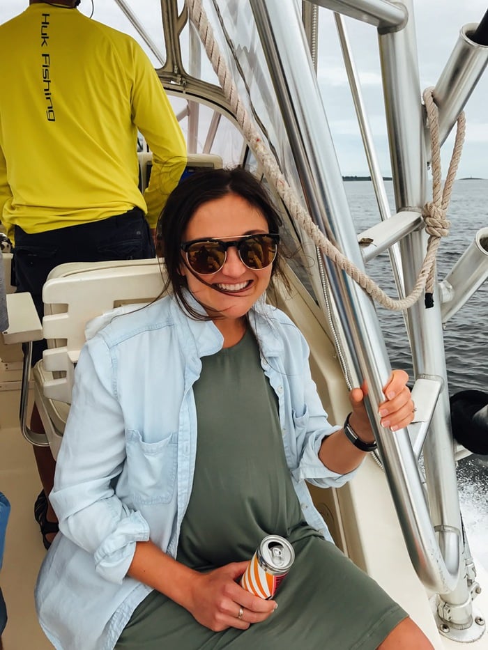 Woman smiling on a boat out on the water.