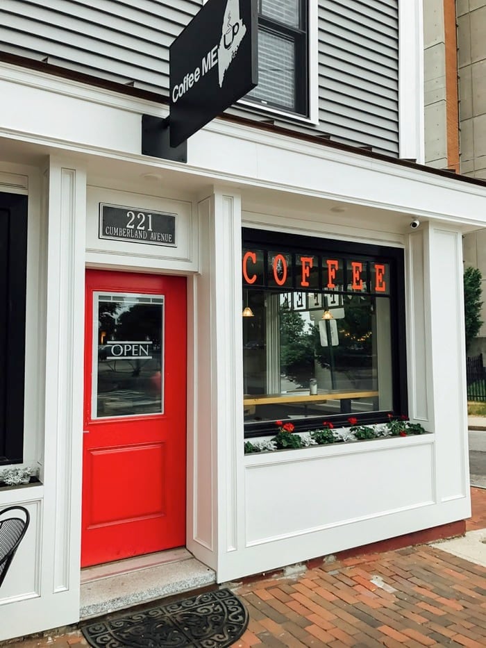 Coffee shop storefront with red door.