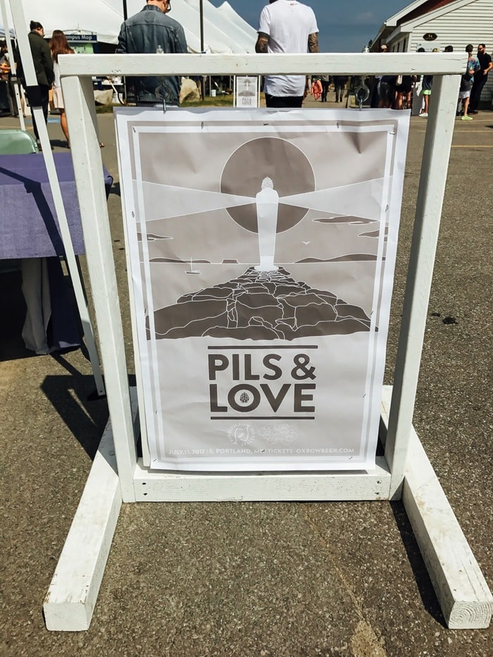 Pils & Love sign with a graphic sketch of a lighthouse on the Portland, Maine coast.