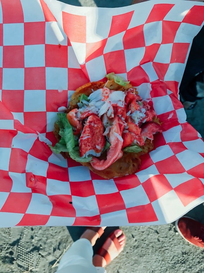 Lobster roll in a red and white check paper.