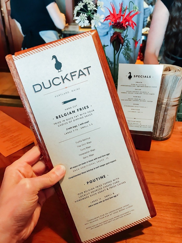 A hand holding Duckfat restaurant menu.