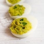 Three avocado deviled eggs.