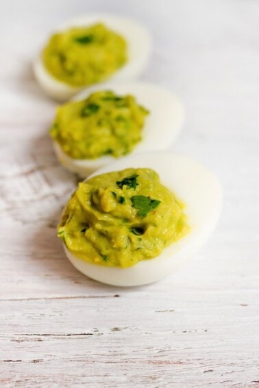 Three avocado deviled eggs.
