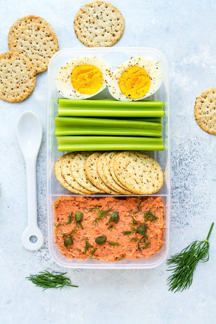 Packable lunch with smoked salmon dip, crackers, celery, and a hard boiled egg. Packable lunch with smoked salmon dip, crackers, celery, and a hard boiled egg.