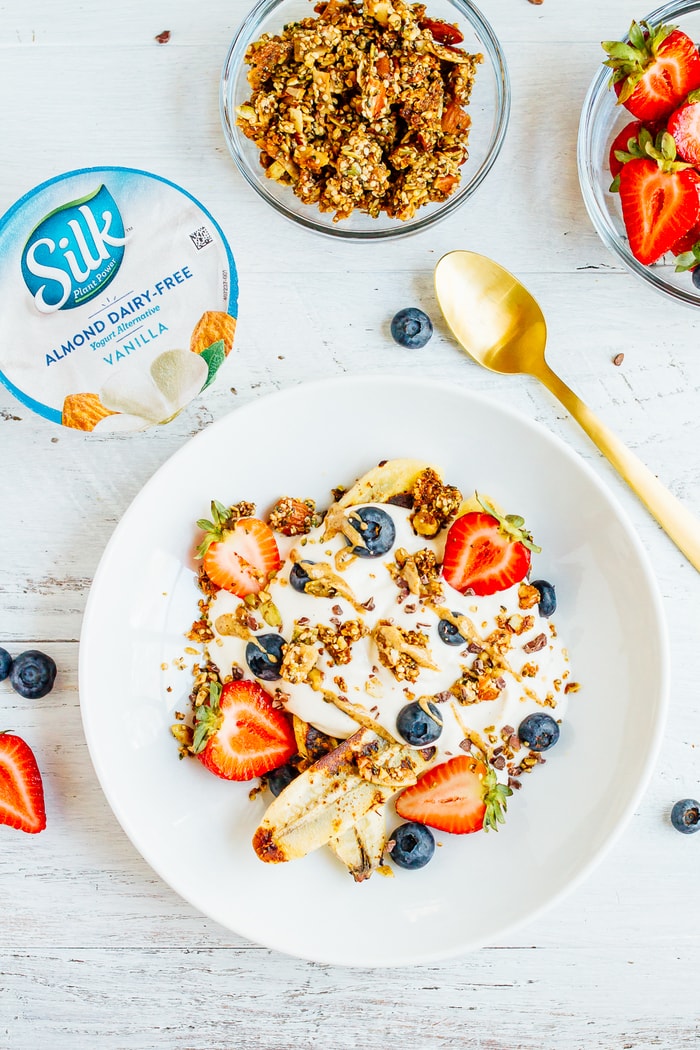 VEGAN Banana split Breakfast Bowl with Dairy-Free Yogurt, Caramelized Bananas, Berries and Grain-Free Granola