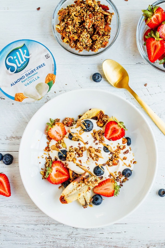 VEGAN Banana split Breakfast Bowl with Dairy-Free Yogurt, Caramelized Bananas, Berries and Grain-Free Granola