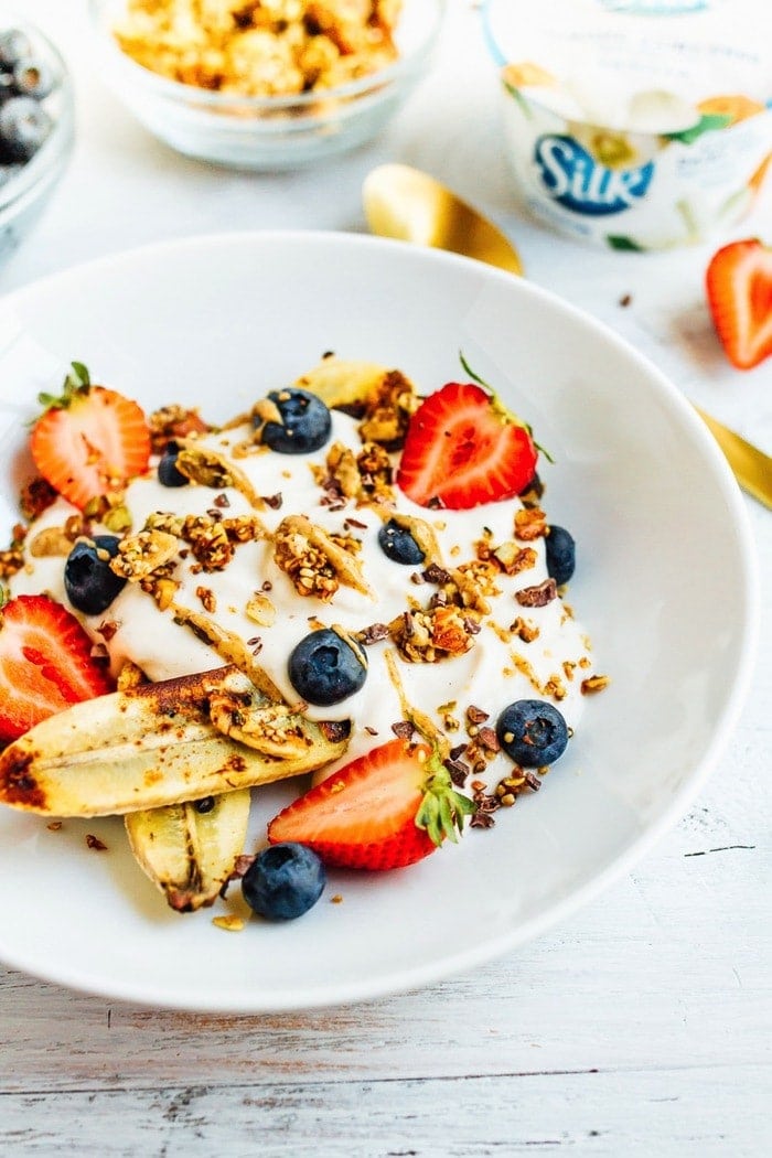 VEGAN Banana split Breakfast Bowl with Dairy-Free Yogurt, Caramelized Bananas, Berries and Grain-Free Granola