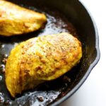 Maple turmeric chicken in a skillet.