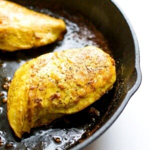 Maple turmeric chicken in a skillet.