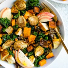 Roasted harvest bowls with veggies, apples, maple turmeric chicken, and an apple cider dressing.