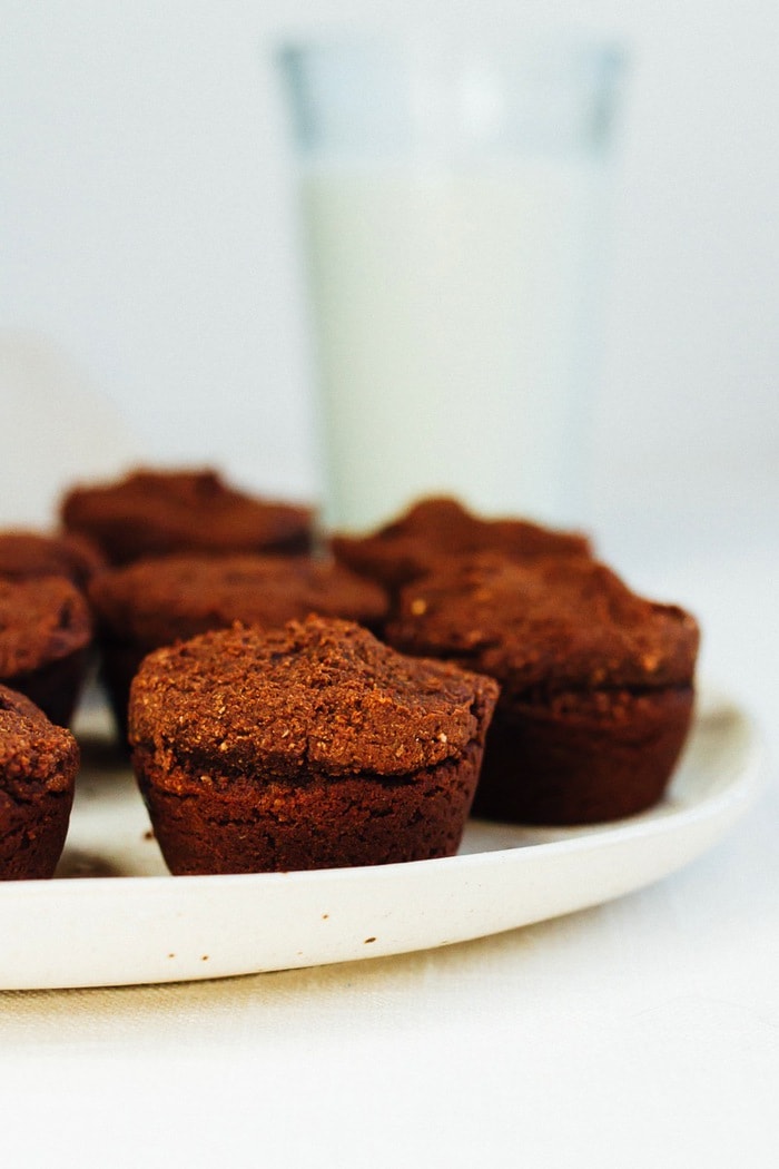 Sweet Potato Brownie Bites served on a large white platter, glass of milk in background.