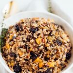 Bowl of wild rice stuffing with butternut squash and dried cherries.