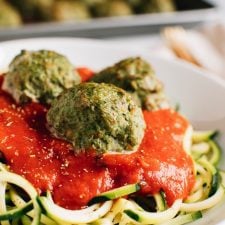 Turkey meatballs over zucchini noodles topped with tomato sauce.
