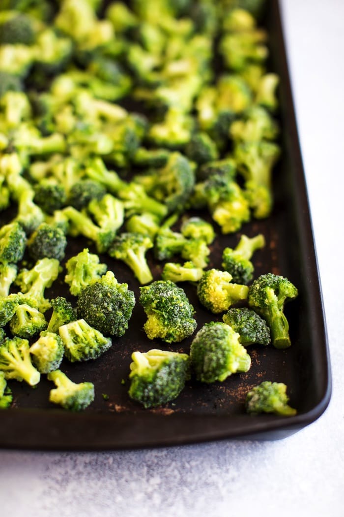 Frozen broccoli on baking sheet.