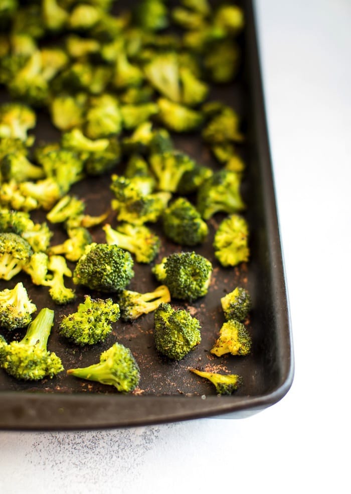 Sheet pan with roasted broccoli.