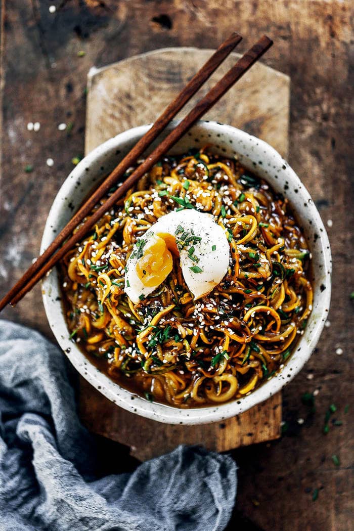 Overhead shot of Whole30 Asian Zucchini Noodle Bowl with soft boiled egg and chopsticks.