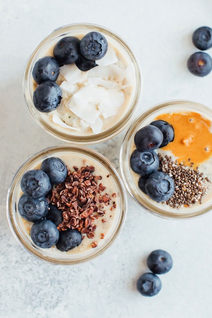 Overhead shot of three pint size mason jars with grain-free overnight "oats"