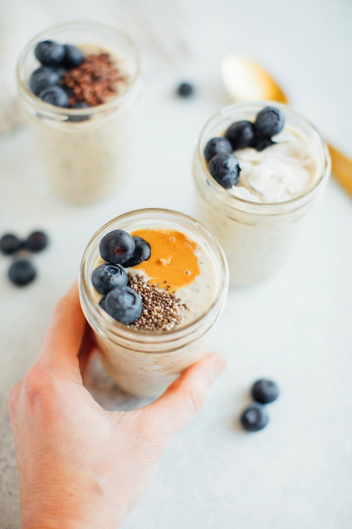 Grain-Free overnight "oats" in a jar being held by a woman's hand. 